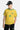 Pull Jbresil Jaune en maille ajourée porté par un mannequin homme, de face, casquette noire, écusson et numéro 10 vert