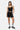 Top Jendala Noir porté avec le short assorti, mannequin femme en pied, de face, baskets noires et chaussettes rayées