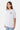 T-shirt Jerusalema Gris Chiné porté par une mannequin femme, de trois quarts, coeur gris brodé sur la poitrine