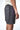Maillot de bain Nibby Noir délavé vu de côté, zip violet et inscription elevenparis blanche à la ceinture