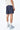 Maillot de bain Nibby Bleu nuit vu de dos, inscription elevenparis à la ceinture, baskets bleues et blanches