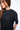 T-shirt Noemie Noir délavé, plan rapproché sur le col rond et l'épaule d'une jeune femme de profil