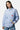 Chemise Penelope Bleu à rayures portée par une mannequin femme de face, broderies coeur, citron et papillon, jean bleu
