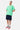 T-shirt Portofino Vert porté en pied par un mannequin homme, de face, trois cœurs, short cargo bleu et baskets roses