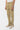 Pantalon cargo Suede Beige porté de trois quarts, poche cargo latérale, baskets beige et blanches