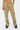 Pantalon cargo Suede Beige porté de face par une mannequin femme, bas de jambe froncé, baskets noires