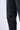 Pantalon Beleo Noir délavé, détail de la jambe avec une fleur de lys noire au genou et couture latérale