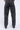 Pantalon Beleo Noir délavé porté de dos, poches arrière et fleurs de lys noires réparties sur les jambes