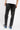 Pantalon Beleo Noir délavé porté de dos par un mannequin homme, fleurs de lys noires, t-shirt blanc et baskets bleues
