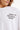 T-shirt Lys Blanc, plan rapproché du buste avec le texte noir Maison 2003 Elevenparis factory et le col rond