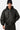 Blouson à capuche Eschott Cuir Noir porté de face par un mannequin homme coiffé d'un bonnet noir à cœur brodé