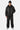 Blouson Eschott Cuir Noir porté en pied par un mannequin homme, bonnet noir, pantalon noir et baskets grises