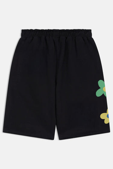 Short Jorine Noir à plat, vue de dos, taille élastiquée et fleurs verte et jaune sur le côté de la jambe