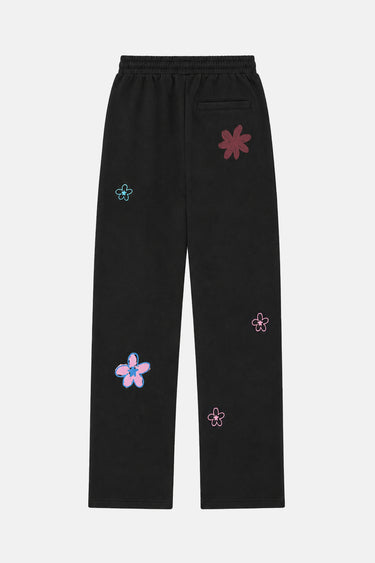 Jogging Tracy Noir vu de dos à plat, poche arrière, cordon de serrage et fleurs brodées multicolores