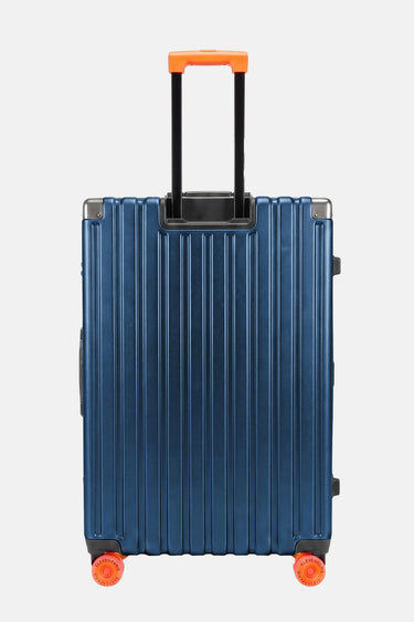 Valise Fugers Bleu Marine M vue de dos, coque rainurée bleu nuit, poignée télescopique et roulettes orange