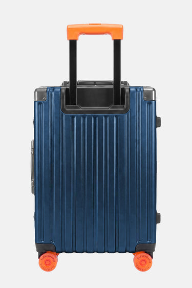 Valise Fugers Bleu Marine S vue de dos, coque rainurée bleu nuit, poignée télescopique et roulettes orange