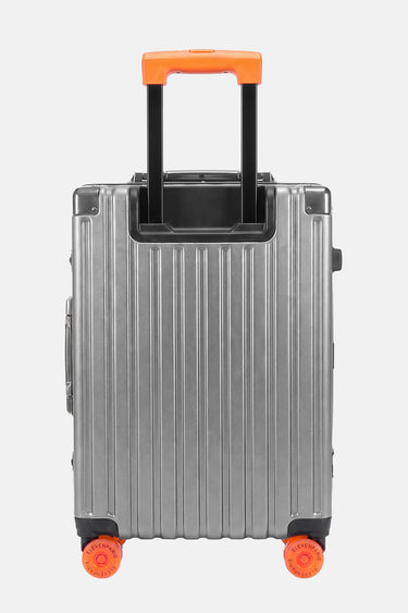 Valise Fugers Argent S vue de dos, coque rainurée gris argenté, poignée télescopique et roulettes orange